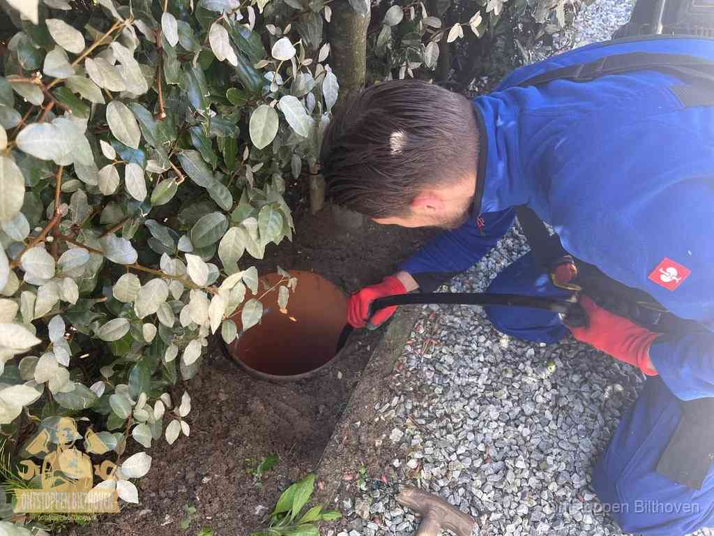 Monteur reinigt een rioolput met een slang, periodieke rioolreiniging in Bilthoven